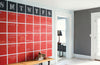 A wall in the entrance of a home that has a painted large red and black calendar the size of the wall, that has been painted with Benjamin Moore's chalkboard paint.